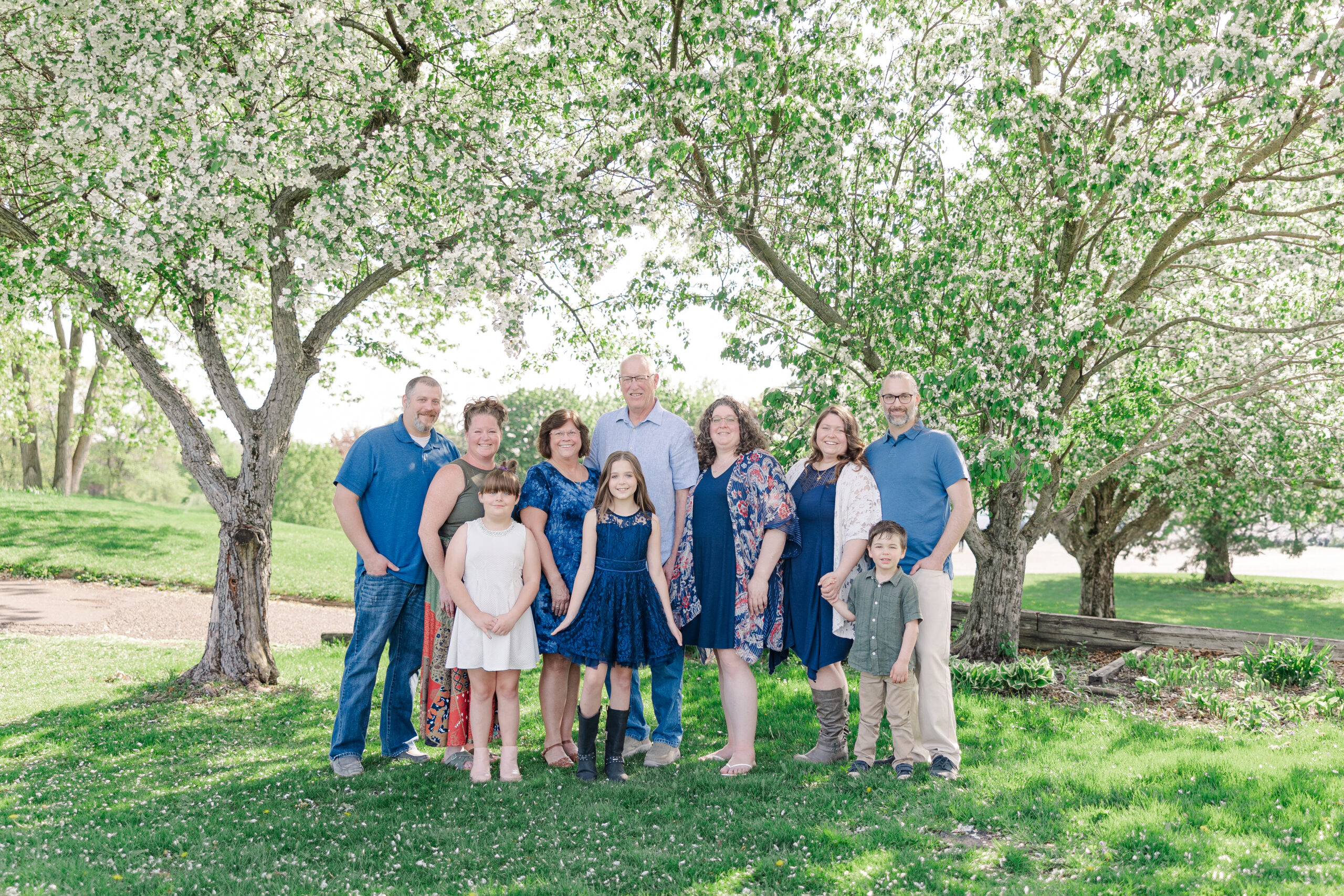 Large family spring portrait in Ham Lake Minnesota surrounded by flower bloomed trees