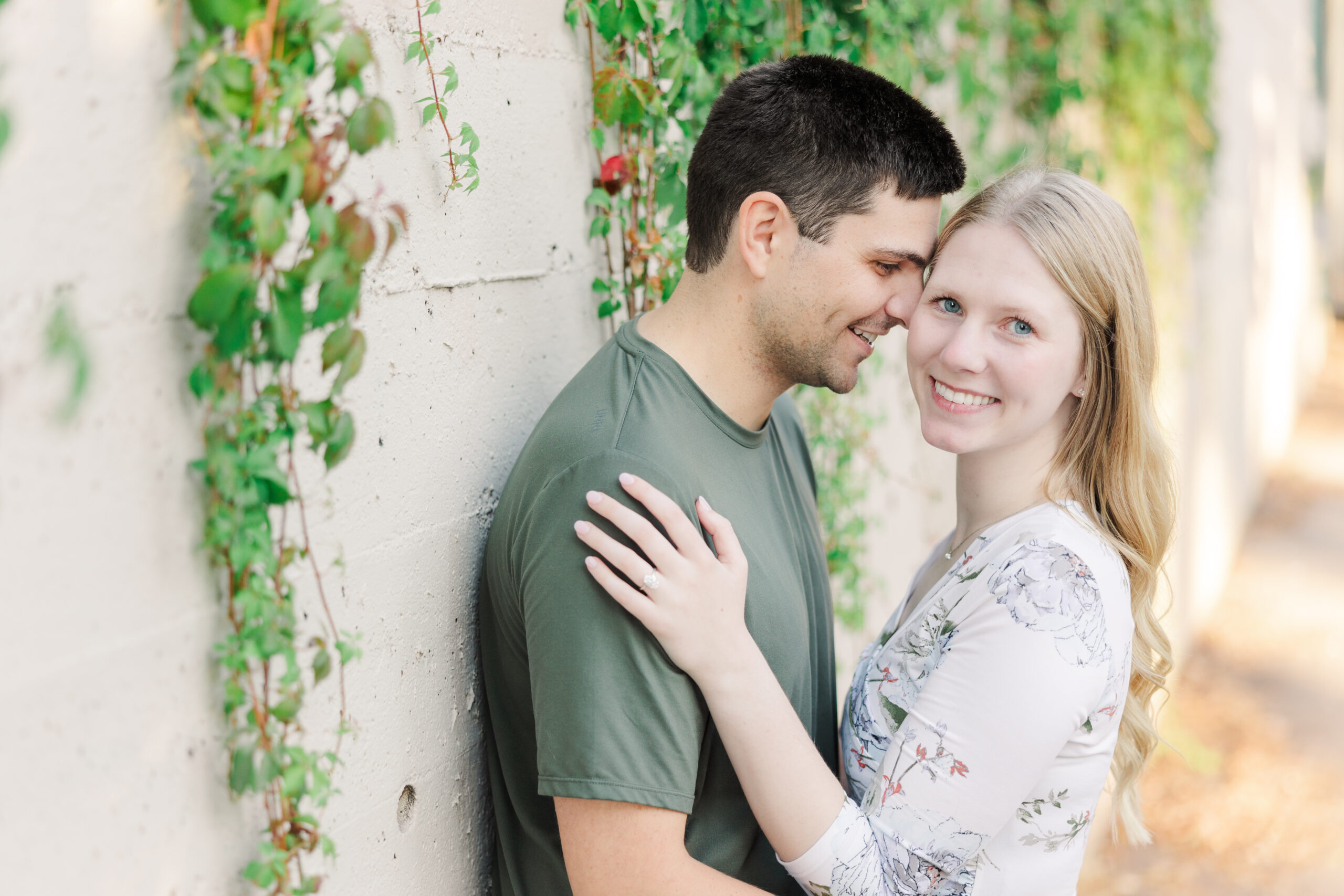 Engagement session at St. Anthony Main in Minneapolis featuring a couple at sunset with the city skyline in the background.