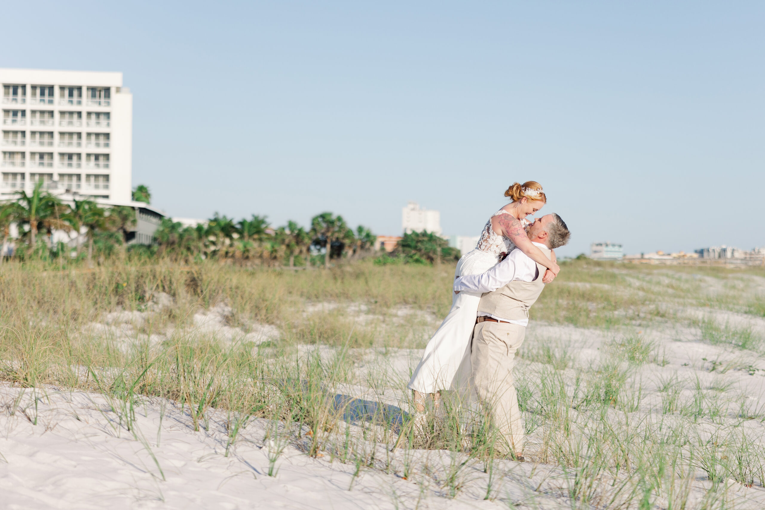 Wedding couple embracing on the beach at Sunset Vistas in Treasure Island, Florida.