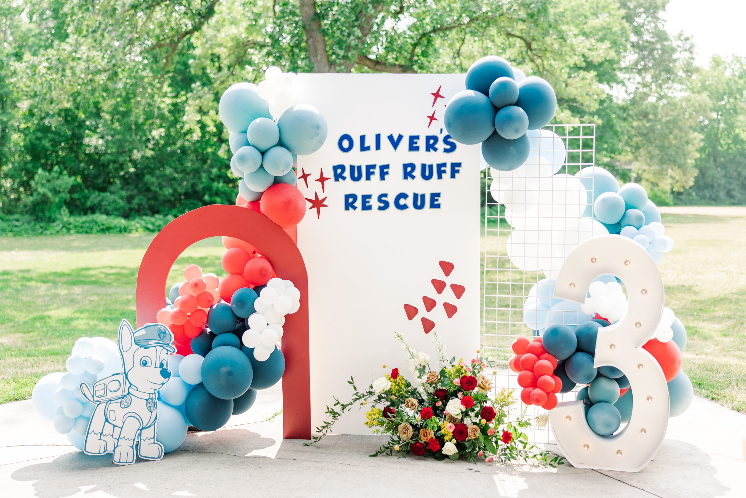 Colorful birthday party setup at Como Park with vibrant balloons, floral decorations, and themed treats for a child's third birthday celebration.