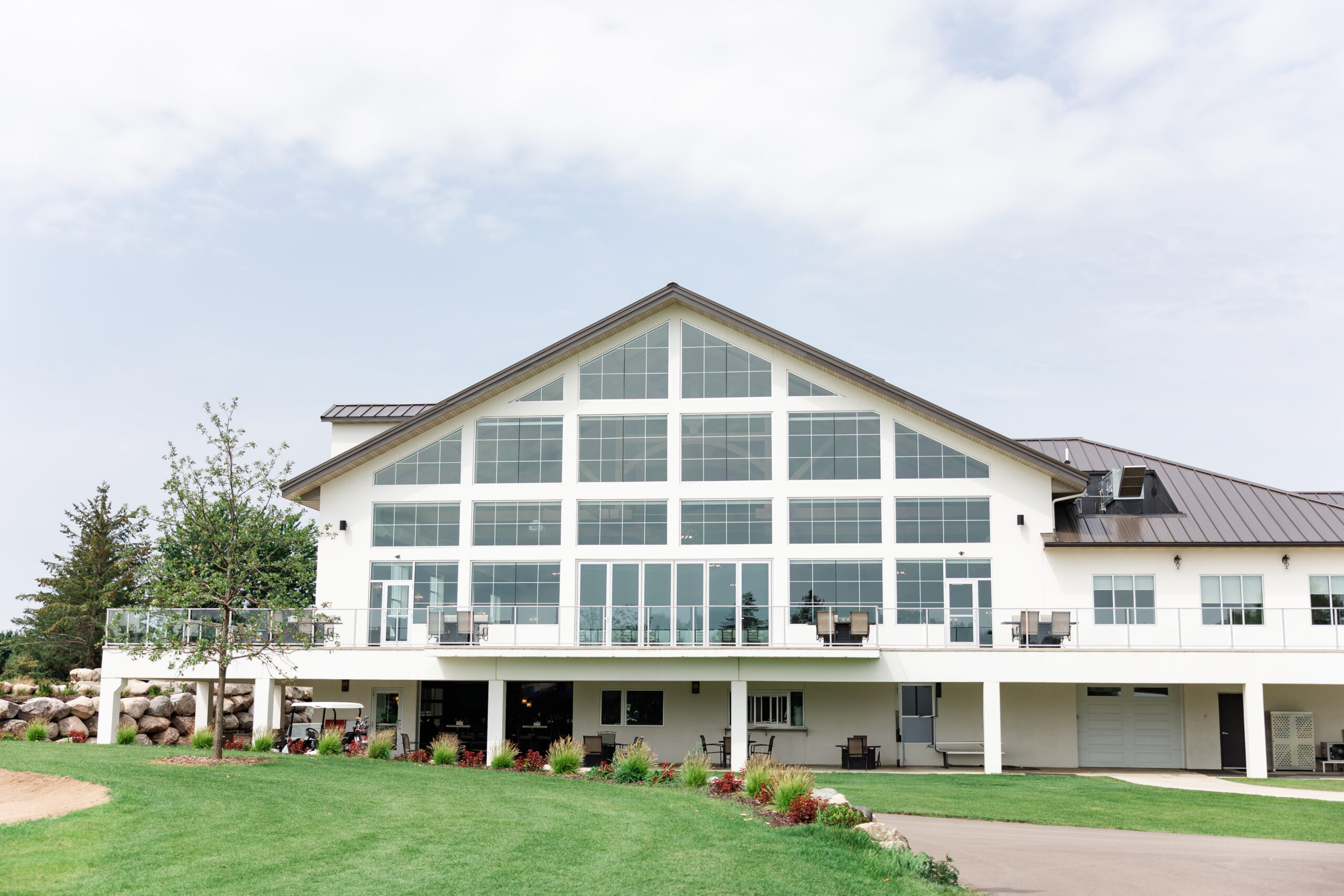 A modern and elegant wedding venue in Minnesota with floor-to-ceiling windows, natural light, and a scenic outdoor ceremony space.