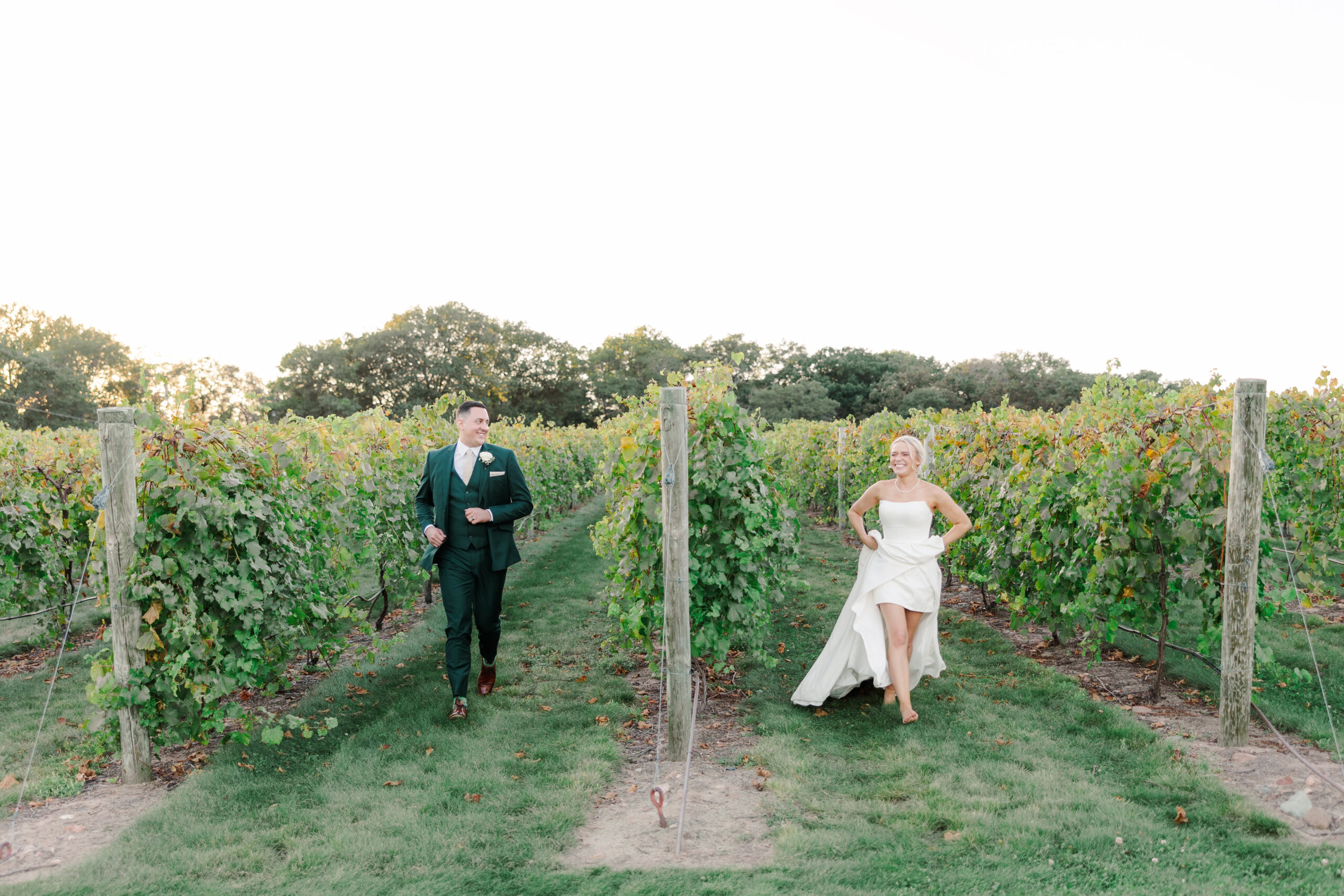 Elegant wedding ceremony with lush floral arch and aisle arrangements photographed by a Minnesota wedding photographer.